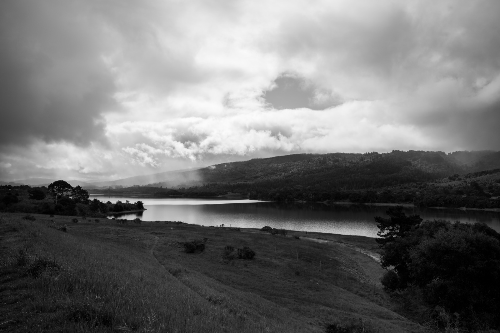 Misty hills and lake landscape